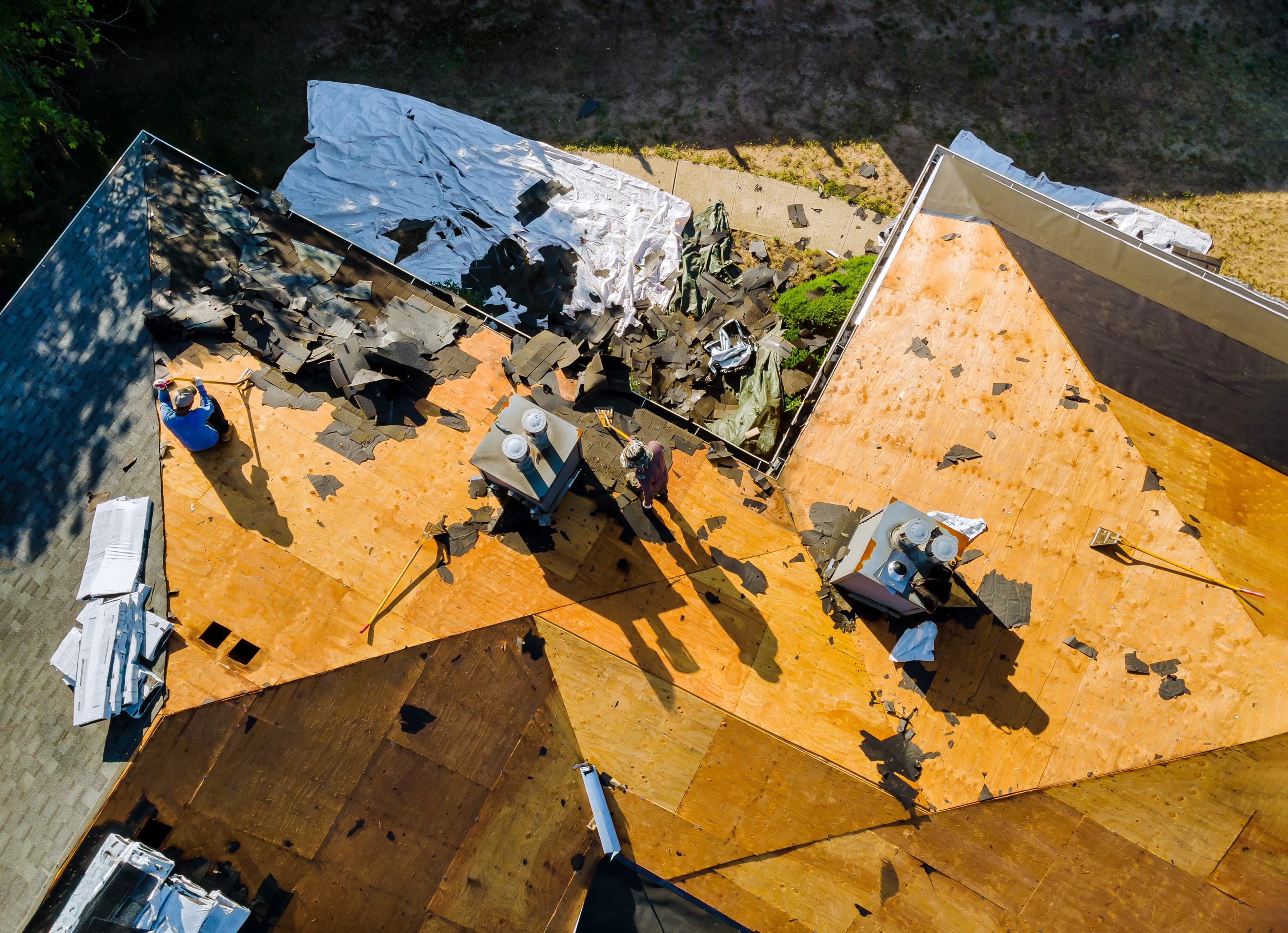 Roofing crew installing new shingles on a residential St. Louis tear-off project.